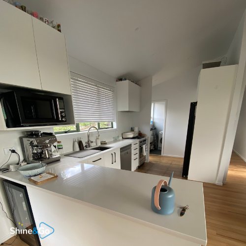 Modern kitchen with black cabinetry cleaned by Shine&Go NZ