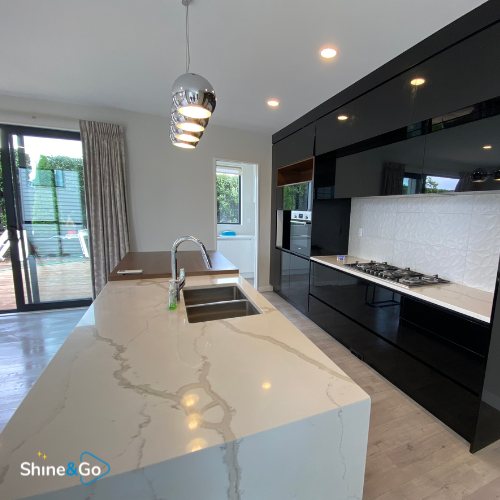 Kitchen with black gloss cabinetry cleaned by Shine&Go NZ
