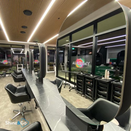 Hair salon with round styling mirrors cleaned by Shine&Go NZ